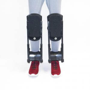 Model in red shoes wearing a pair of K2S-250 Knee Pads with Quick change wear pads and K2S-500 leg extension attached to knee pads